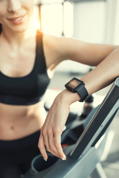 Young attractive woman resting after workout on treadmill — Stock Photo, Image