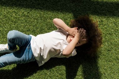 girl lying on grass clipart