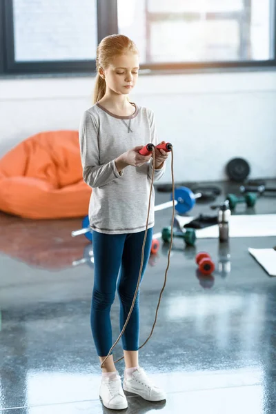 Молода дівчина з пропускаючою мотузкою в фітнес-студії — стокове фото