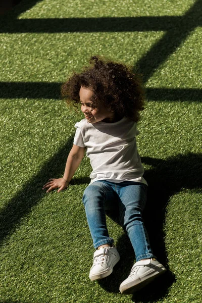 Girl sitting on grass — Free Stock Photo