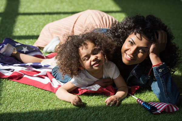 woman with daughter on american flag