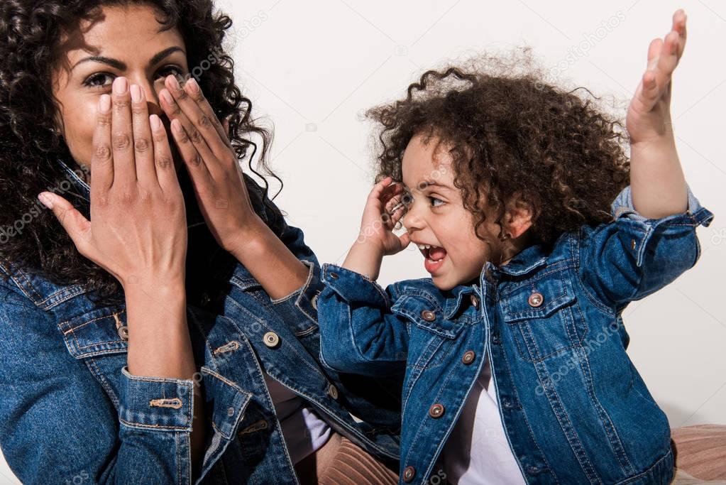mother playing hide-and-seek with daughter