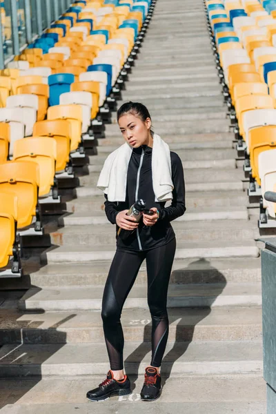 Tired sportswoman on stadium seats — Free Stock Photo