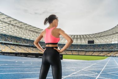 Sportswoman exercising on stadium  clipart