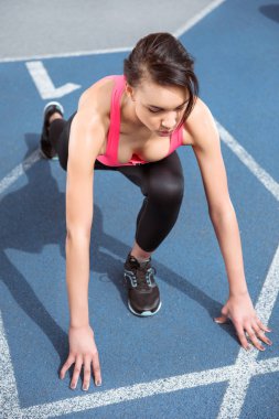 Sportswoman on starting line  clipart