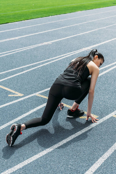 Sportswoman on starting line 