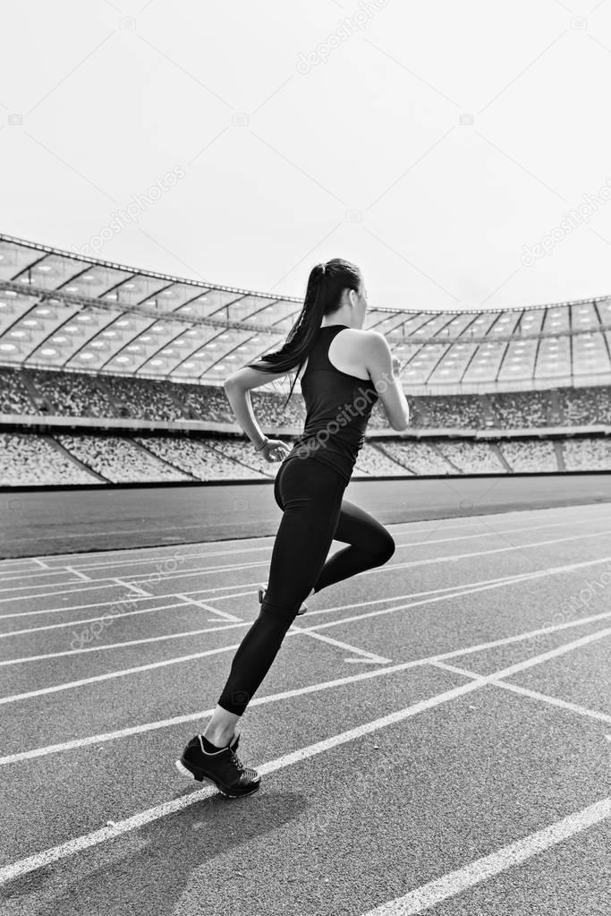 Sportswoman running on stadium 