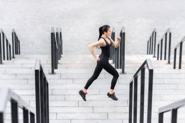 Sportswoman training on stadium stairs  clipart
