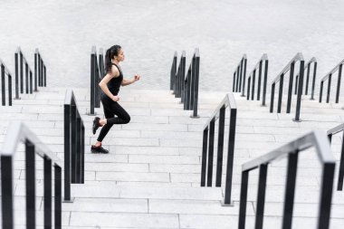 Sportswoman training on stadium stairs  clipart