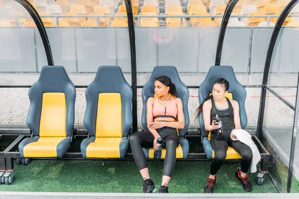 Sportswomen resting on stadium — Free Stock Photo