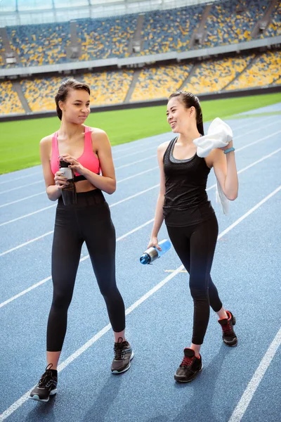 Sportswomen resting on stadium — Free Stock Photo