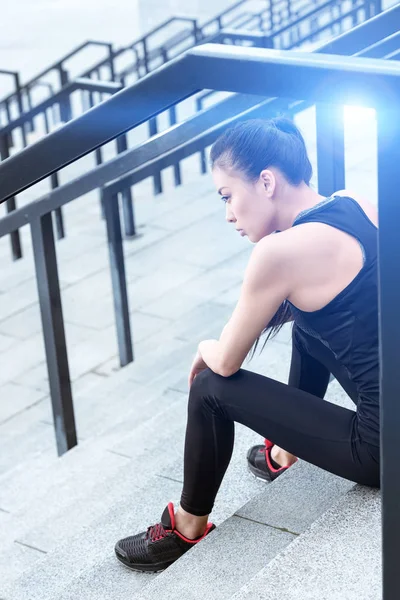 Sportswoman training on stadium stairs — Free Stock Photo
