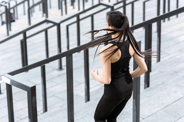 Sportswoman training on stadium stairs — Stock Photo, Image