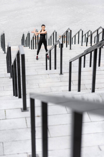 Sportswoman training on stadium stairs 