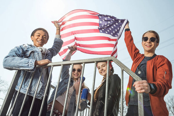 teenagers waving american flag