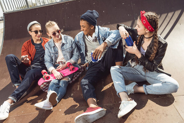 teenagers posing in skateboard park 