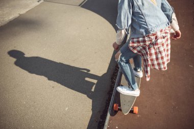 hipster girl riding skateboard  clipart