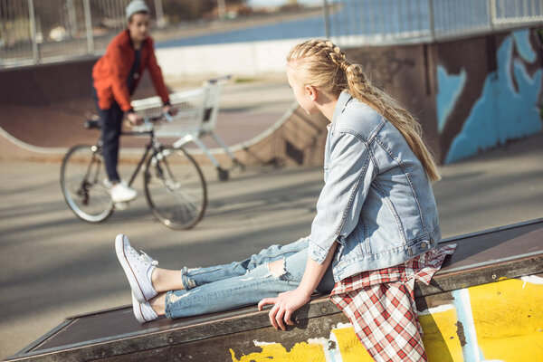 girl resting at skateboard park