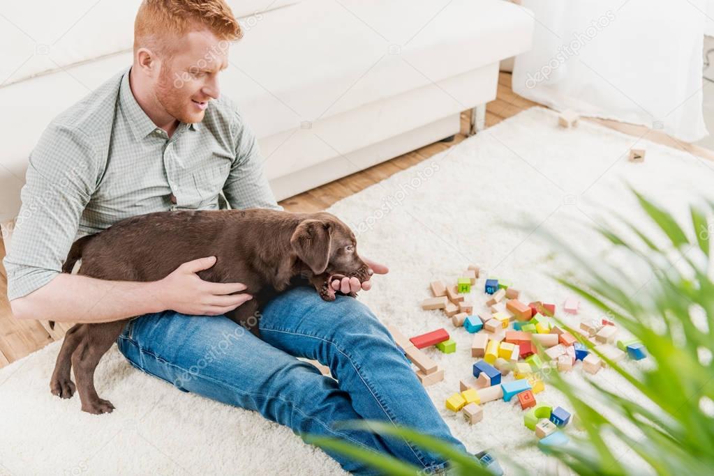 man holding puppy 