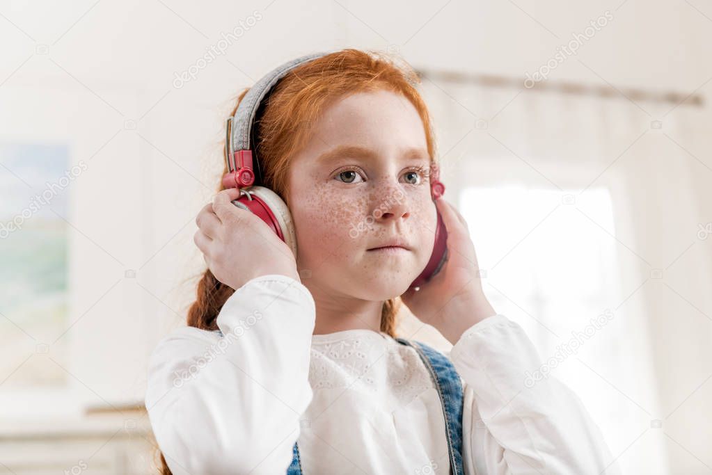 little girl in headphones