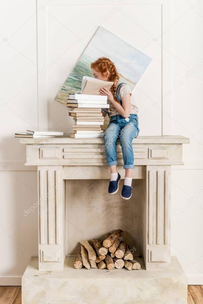 little girl and pile of books