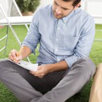 Businessman writing on paper