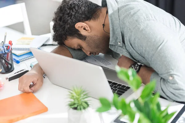 Hombre de negocios durmiendo en la mesa cerca del ordenador portátil — Foto de Stock