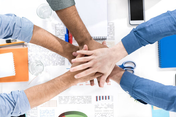 Businessmen stacking hands  