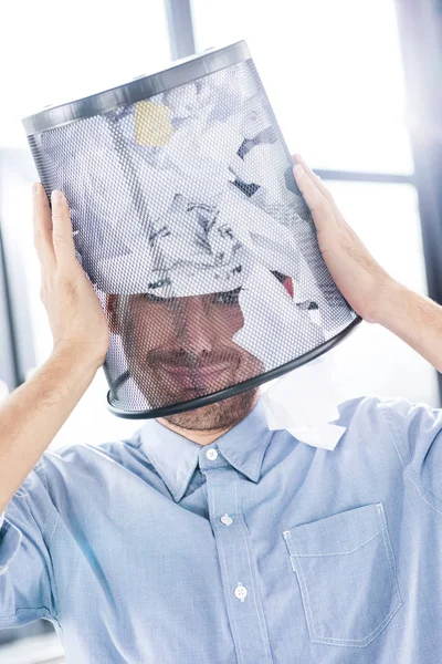 Businessman with trash bucket on head — Free Stock Photo