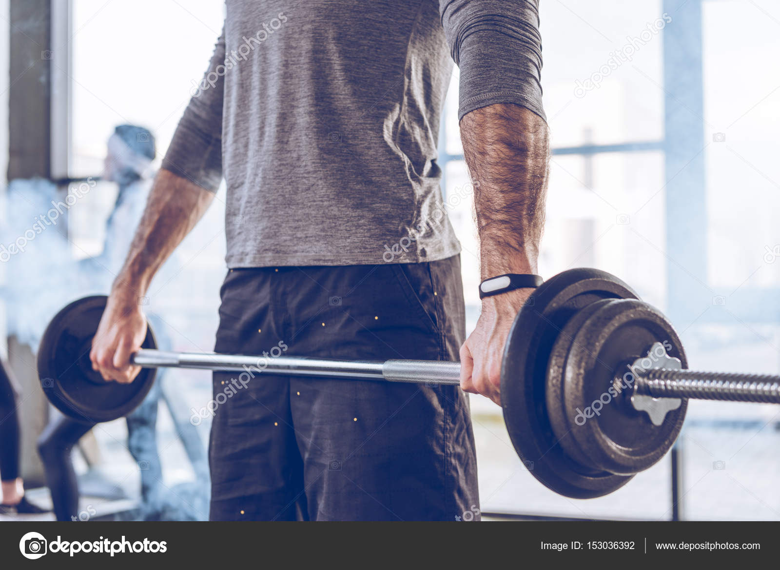 Sportsman lifting barbell — Stock Photo © ArturVerkhovetskiy 153036392