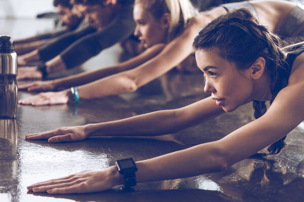 sporty people exercising in gym  