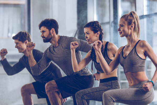 sporty people exercising in gym 