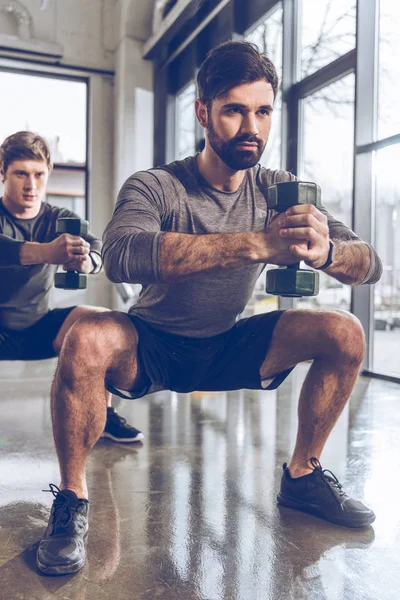 Jeunes sportifs faisant de l'exercice en salle de gym — Photo