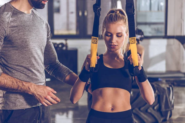 Sportive woman with trx equipment — Stock Photo, Image