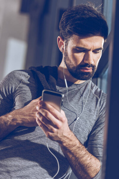 man listening music in earphones