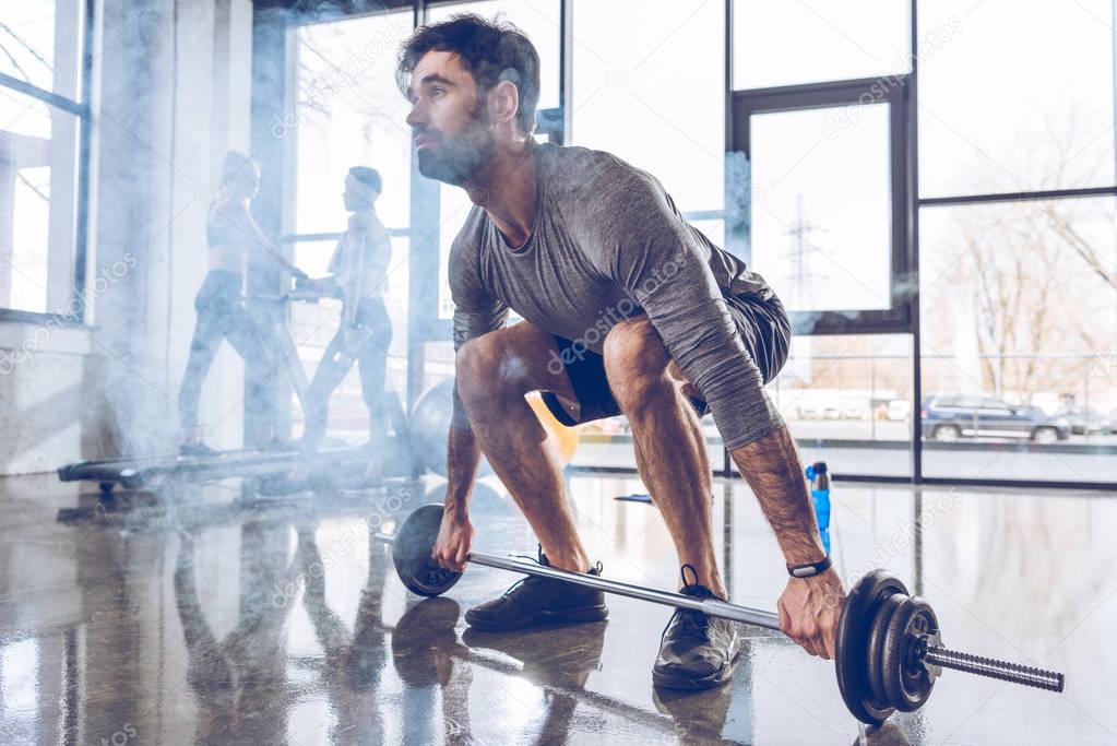 Sportsman lifting barbell 