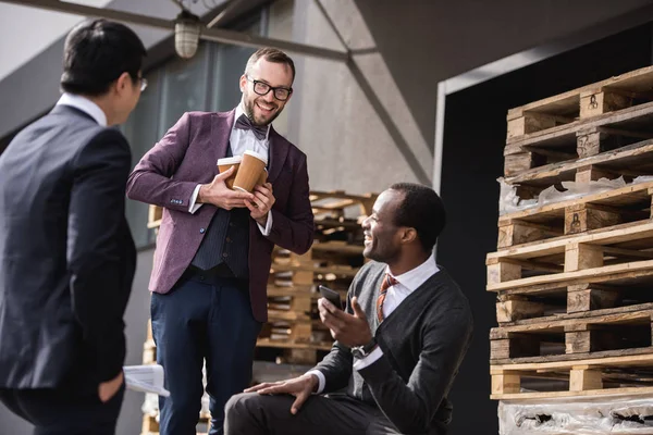 Young multiethnic businessmen in formalwear meeting at coffee break outdoors, business team meeting — Stock Photo, Image