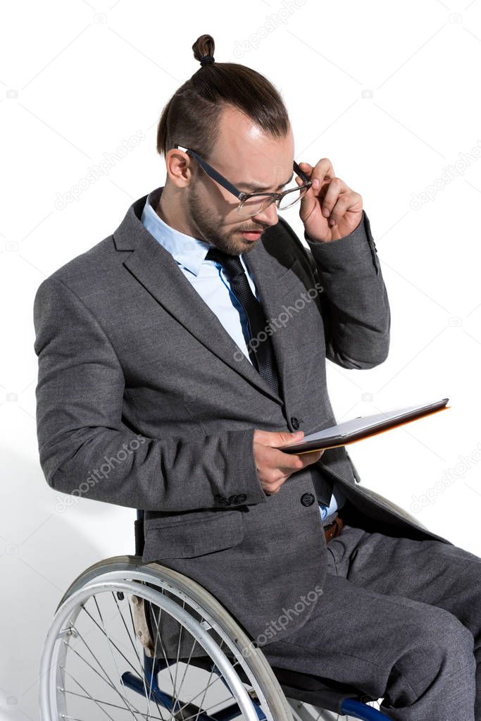 physically handicapped businessman with digital tablet
