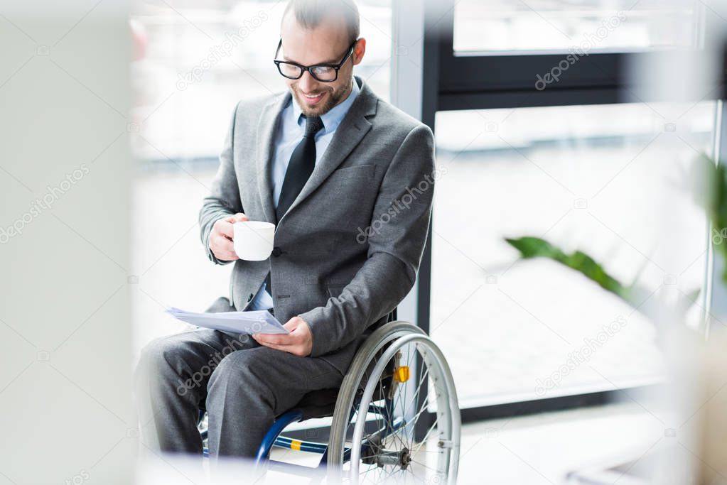 physically handicapped businessman drinking coffee