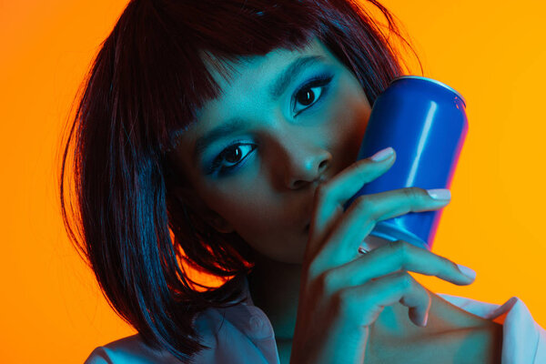 african american woman holding can