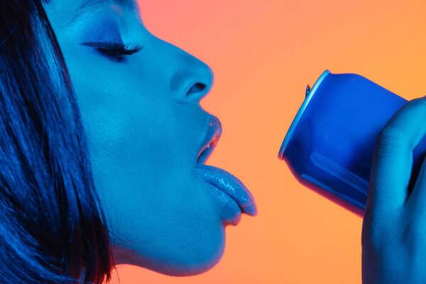 girl drinking from can with loll out