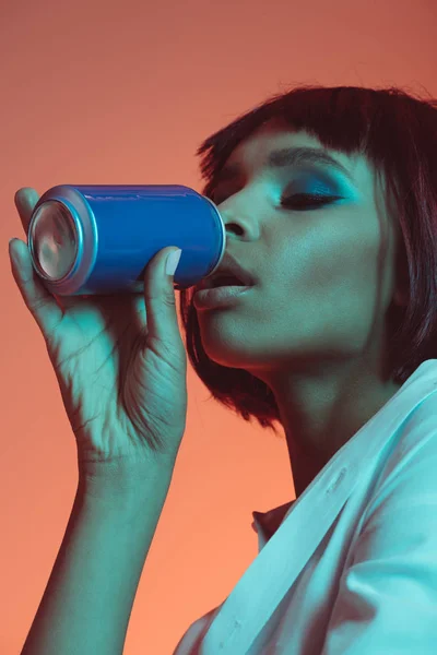 African american girl drinking from can — Stock Photo, Image