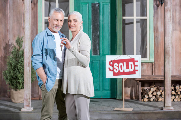 senior couple with new house keys