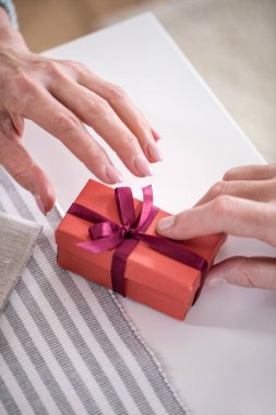 man presenting gift to wife clipart