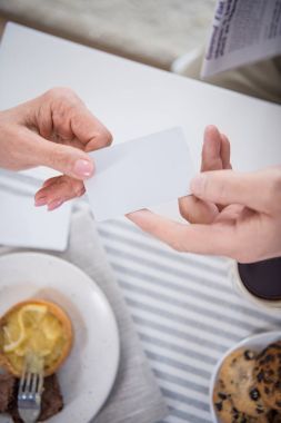 man passing blank card to woman clipart