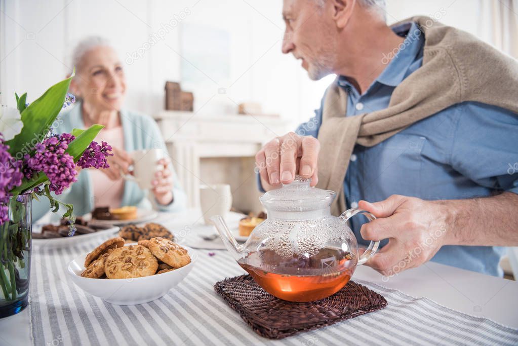 senior couple drinking tea at home