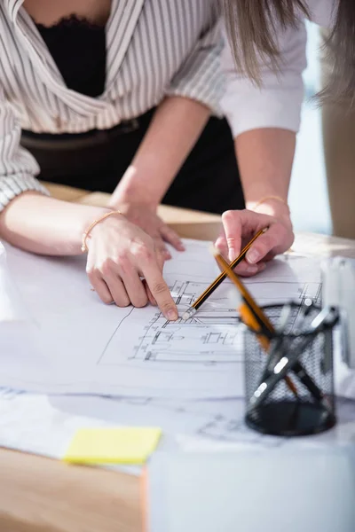 Designers pointing with finger on blueprints — Stock Photo, Image