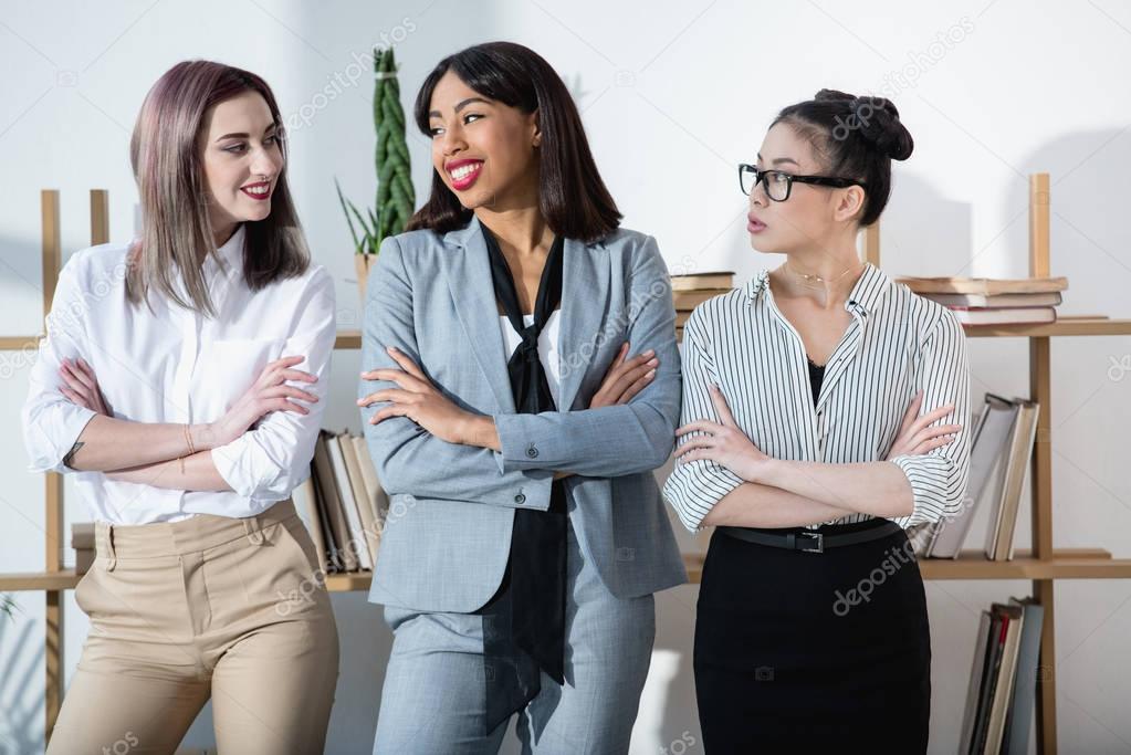 smiling multiethnic businesswomen in formal wear