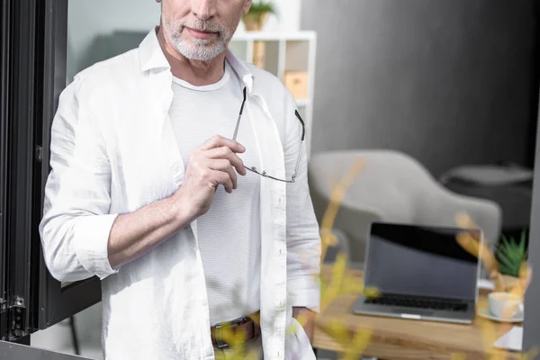 Businessman near window at office — Free Stock Photo