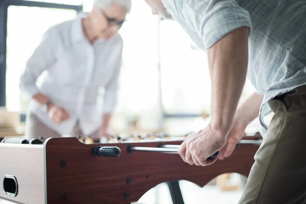 Colleagues playing foosball — Free Stock Photo